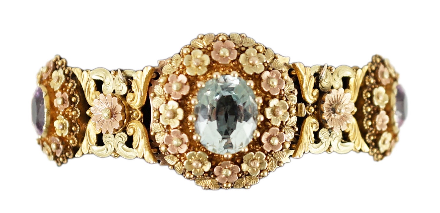 A 19th century pierced three colour gold, pink topaz, moonstone, citrine and aquamarine set bracelet.